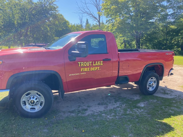 Trout Lake Fire Department pickup truck parked on the grass.