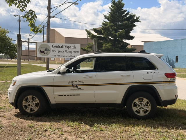 Emergency jeep Infront of Emergency Management and Central Dispatch Sign